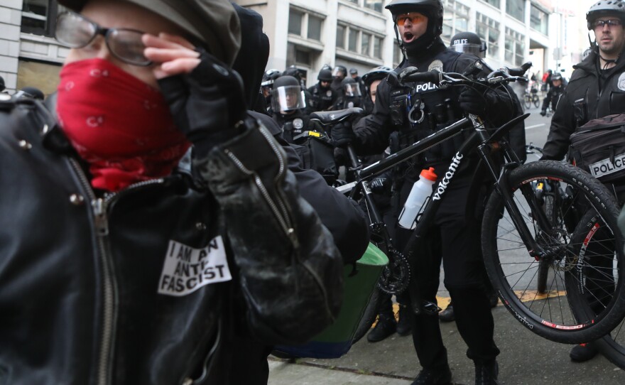 Seattle police officers use mountain bikes as crowd control devices while attempting to disperse anti-fascist protesters during the United Against Hate rally in Seattle last month.