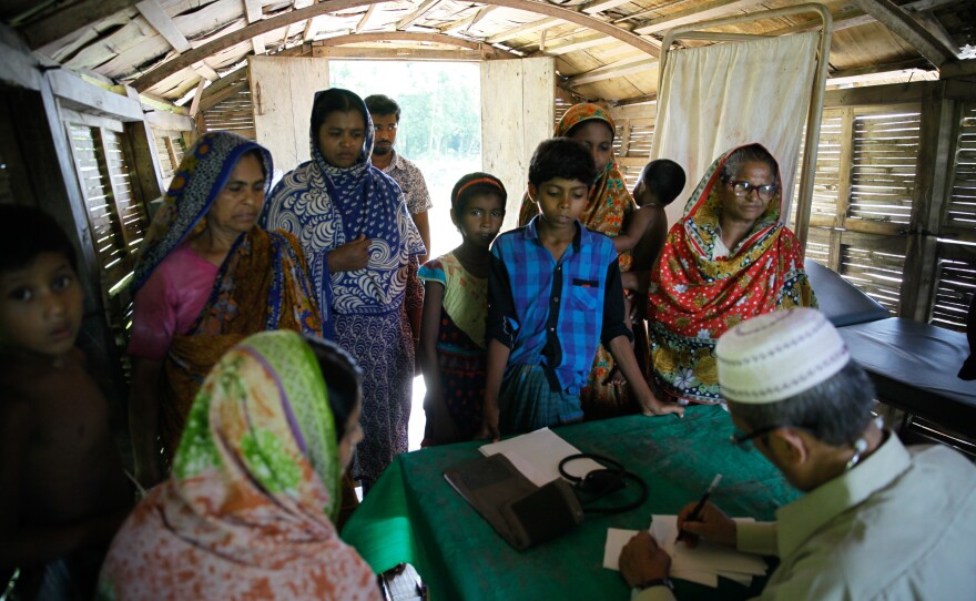 Villagers wait to see a doctor at a Shidhulai Swanirvar Sangstha floating clinic. On different days the boat docks at different points along the river.