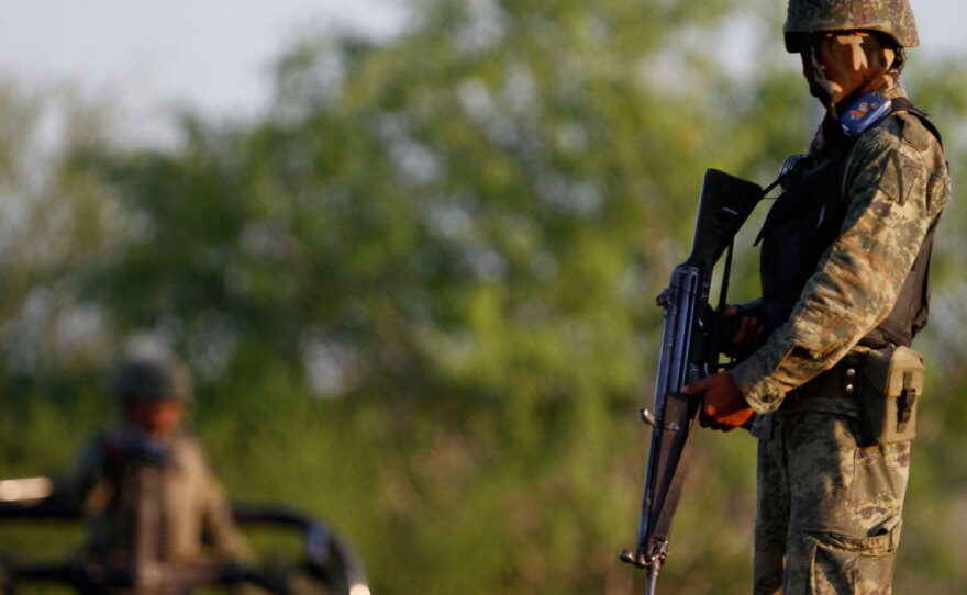 A soldier stands guard at a crime scene in Monterrey.