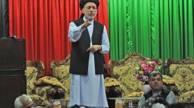 Afghan President Hamid Karzai speaks at a meeting with tribal leaders Sunday in Kandahar. Karzai appealed to hundreds of tribal and religious leaders at the <em>jirga </em>to support a major operation in their southern province, the heartland of a Taliban insurgency.