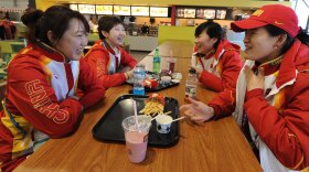 Chinese short-track speedskaters eat in the dining hall during a media tour of the Olympic Village in downtown Vancouver on Feb. 9.
