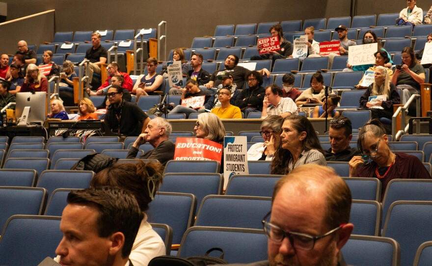 Members of the public carried their signs into the meeting, many brought the signage to the podium during public comment on Nov. 13, 2025.