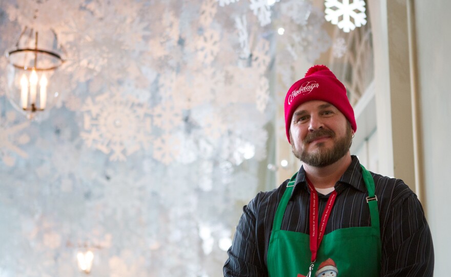 Trevor Smith helped hang thousands of paper snowflakes in the East Colonnade. He run a landscaping and floral design firm together in Boston with his fiance Christina Donovan who was also selected as a volunteer.