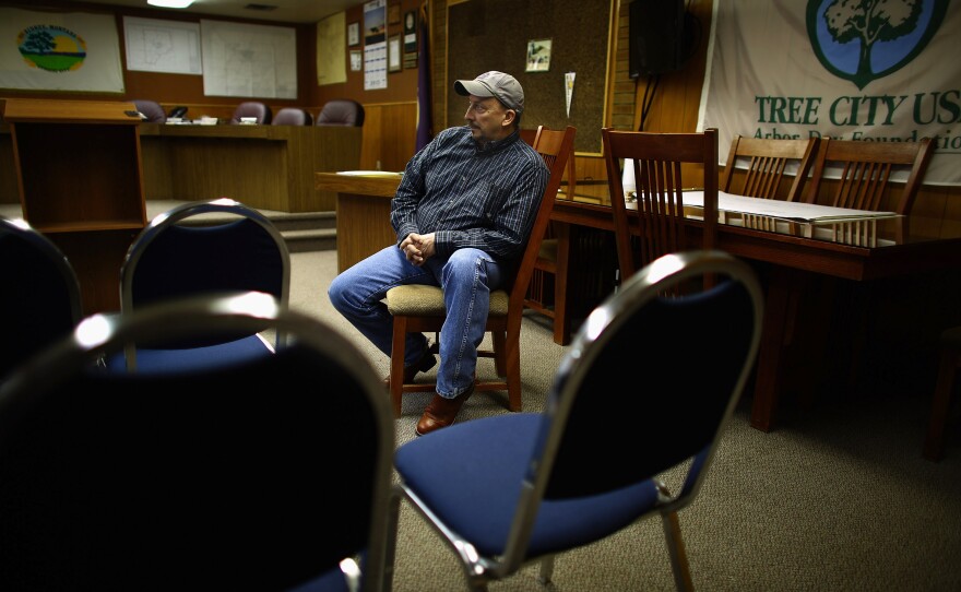 Mayor Rick Norby sits in the city council chambers of Sidney, Mont.'s town hall. He was elected to the city council in 2008, serving six years before being elected mayor last year.