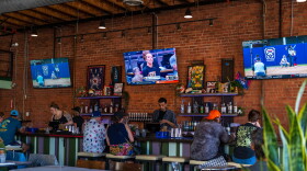 Customers sitting at the bar watch women's basketball and softball at One of Us in North Park on July 22, 2026. One of Us is San Diego's first women's sports bar.