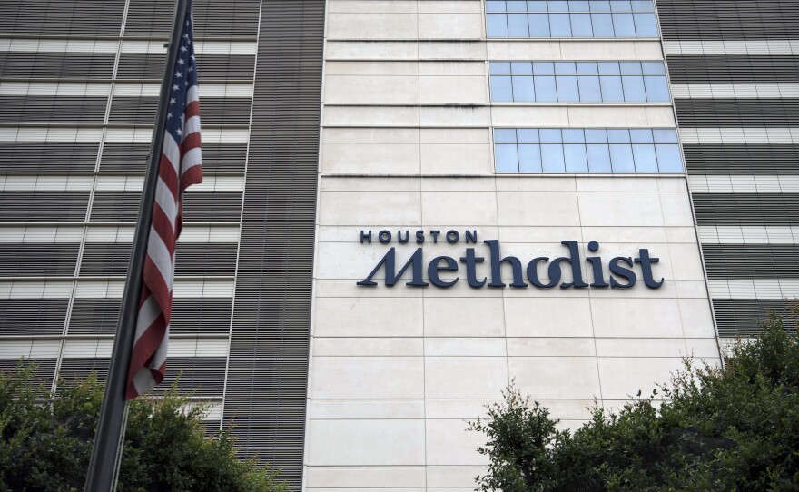 An American flag flies outside of Houston Methodist Hospital in June 2020. A federal judge has thrown out a lawsuit by hospital employees who have refused to comply with a mandate requiring they receive a COVID-19 vaccine.