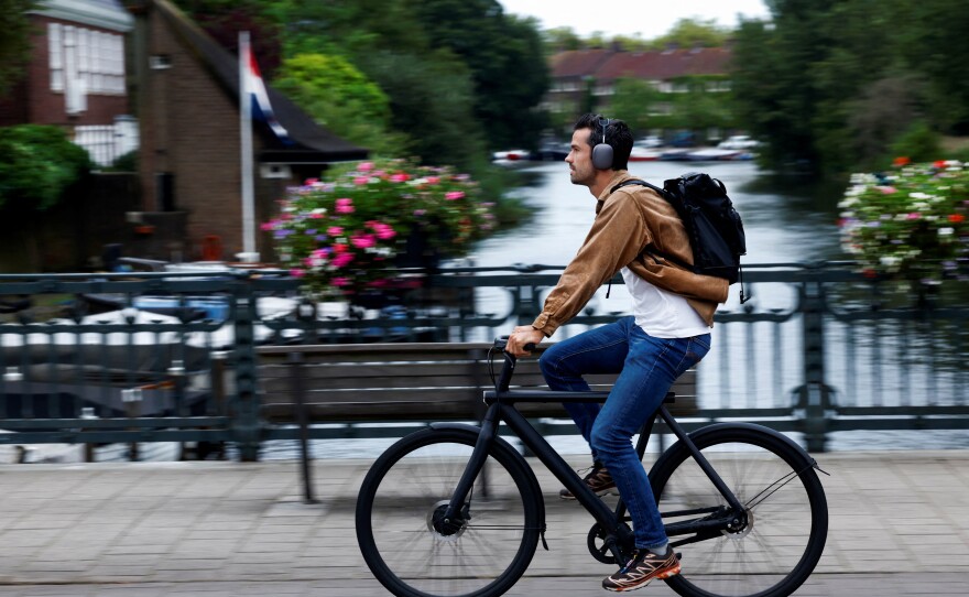 A man rides a VanMoof brand e-bike in Amsterdam, Netherlands, Aug. 17.