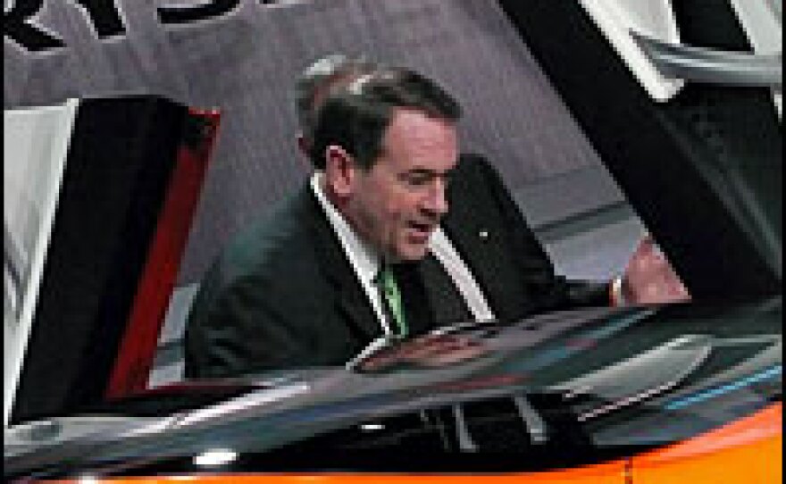 Republican presidential candidate Mike Huckabee looks at a Chrysler concept car on Monday.