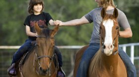 Rowan (left) and Rupert Isaacson riding horses at home in Texas.