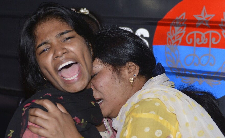 Women mourn the death of relatives after a bomb blast in Lahore, Pakistan, on Sunday.