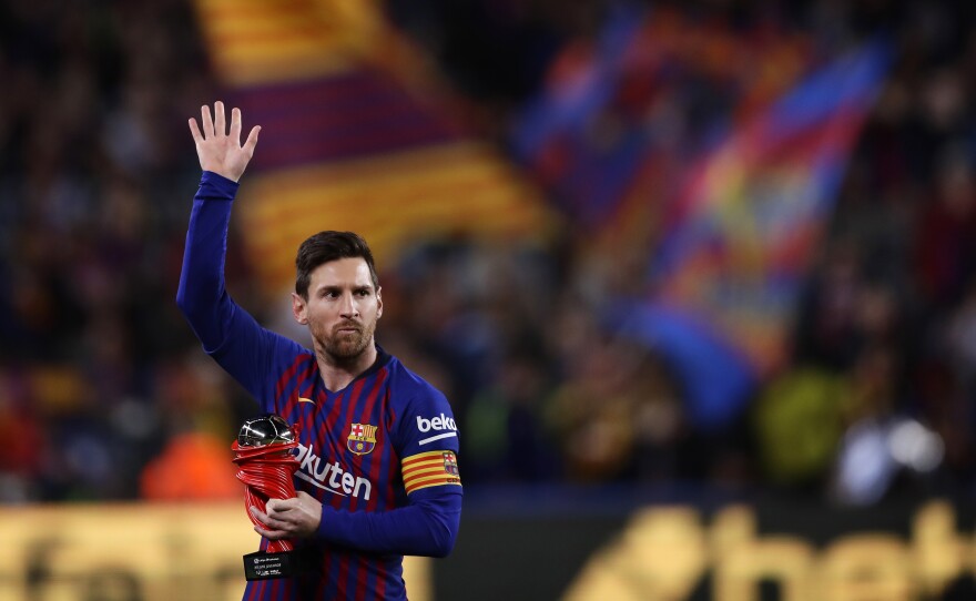 In this 2019 file photo, Lionel Messi waves at the crowd as he holds the trophy of the best Spanish La Liga player prior to a soccer match between FC Barcelona and Atletico Madrid at the Camp Nou stadium in Barcelona, Spain. Barcelona says Lionel Messi will not stay with the club.