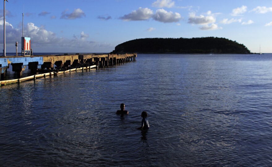 Two people swim at a beach in Vieques, Puerto Rico. One of the bays on the island is famous for its bioluminescent plankton, which are slowly recovering after Hurricane Maria.