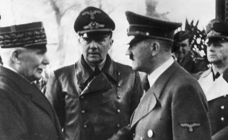 German Chancellor Adolf Hitler shakes hands with Head of State of Vichy France Marshall Philippe Pétain in occupied France on Oct. 24, 1940.