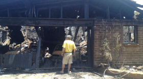 Carlsbad resident Gregory Saksa inspects the remains of his home, destroyed by the Poinsettia fire on Wednesday.