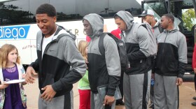 Members of the Baylor Bears football team get off the bus as they spend an afternoon visiting the San Diego Zoo. Baylor and UCLA play in this year's Holiday Bowl. 