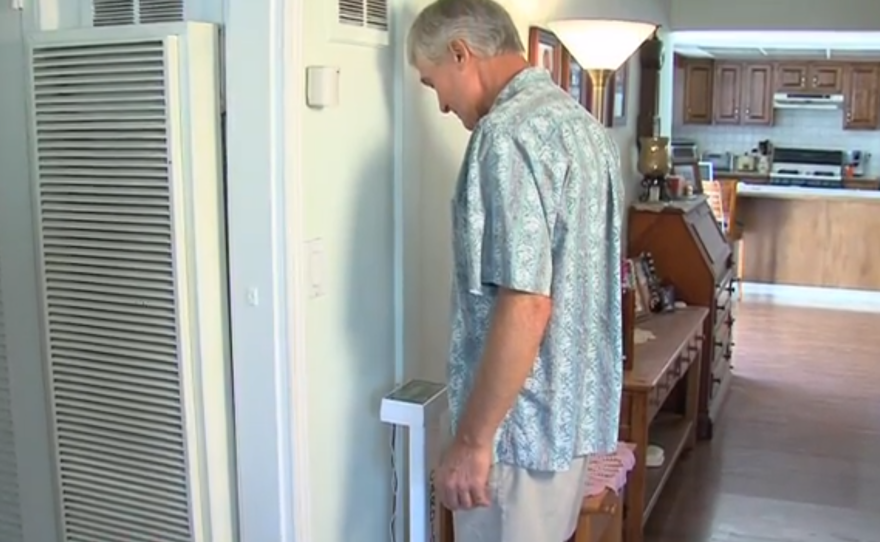 Steven White steps on a special scale that helps monitor his congestive heart failure.