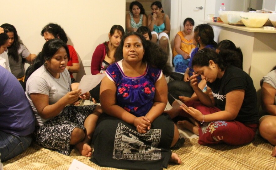 At a party outside Brisbane, Australia, nursing students sing i-Kiribati songs.