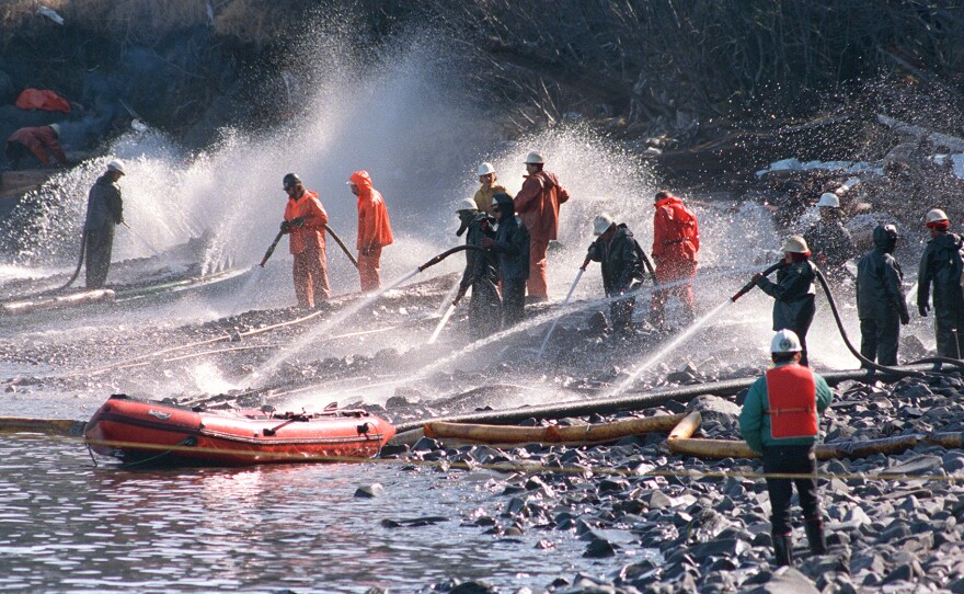 Workers try to remove some of the 11 million gallons of oil spilled by the Exxon Valdez off Alaska in 1989. The ship's third mate may have been up for 18 hours before the accident.