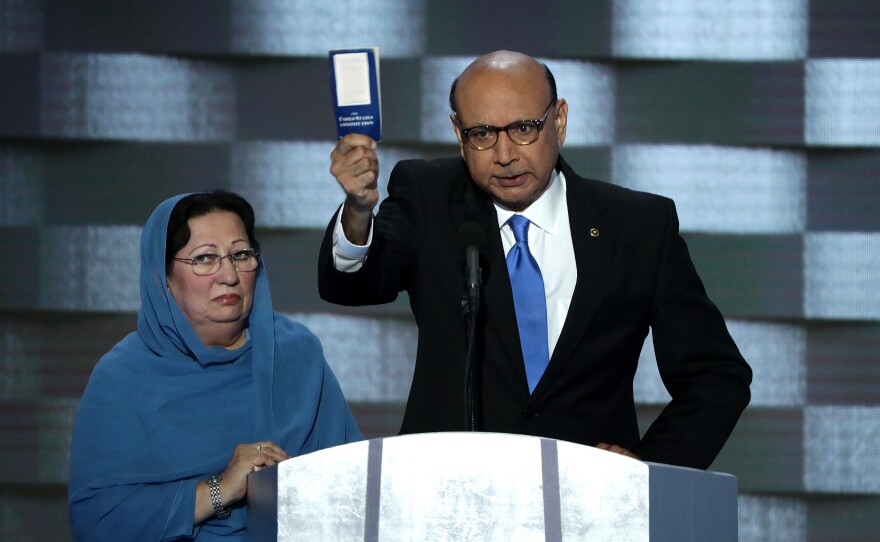 Khizr Khan, father of deceased soldier Humayun S.M. Khan, holds up a copy of the U.S. Constitution as he delivers remarks on the final day of the convention.