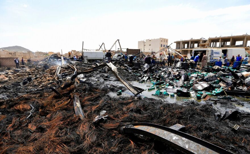 Workers search through debris at a warehouse, after it was reportedly hit in an airstrike by the Saudi-led coalition, in the Yemeni capital Sanaa on July 2, 2020. More than 233,000 people have died as a result of the war.