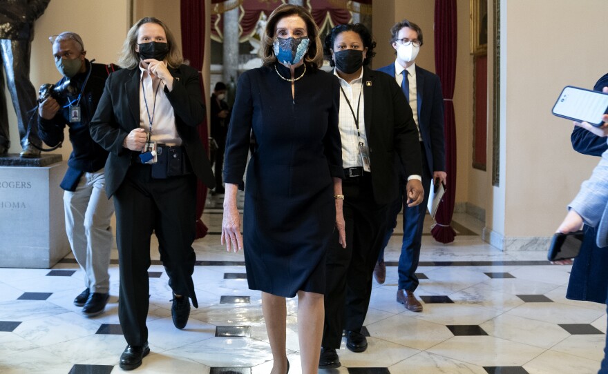 House Speaker Nancy Pelosi, D-Calif., said that impeaching President Trump is "a constitutional remedy that will ensure that the republic will be safe from this man." She's seen here walking to the House floor on Wednesday, ahead of the vote.