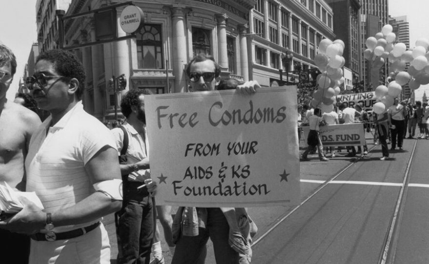 Volunteers march and distribute education literature and condoms at the Gay & Lesbian Freedom Day Parade in San Francisco, 1983.