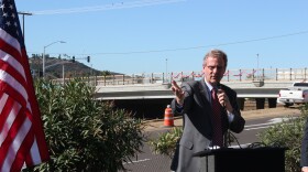 San Marcos mayor Jim Desmond marks the re-opening of the Nordahl Bridge, which is seen in the background. 