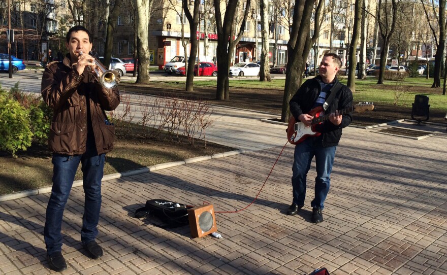 Unfazed by the political turmoil a few blocks away, street musicians in Donetsk play Adele songs on Pushkin Boulevard.