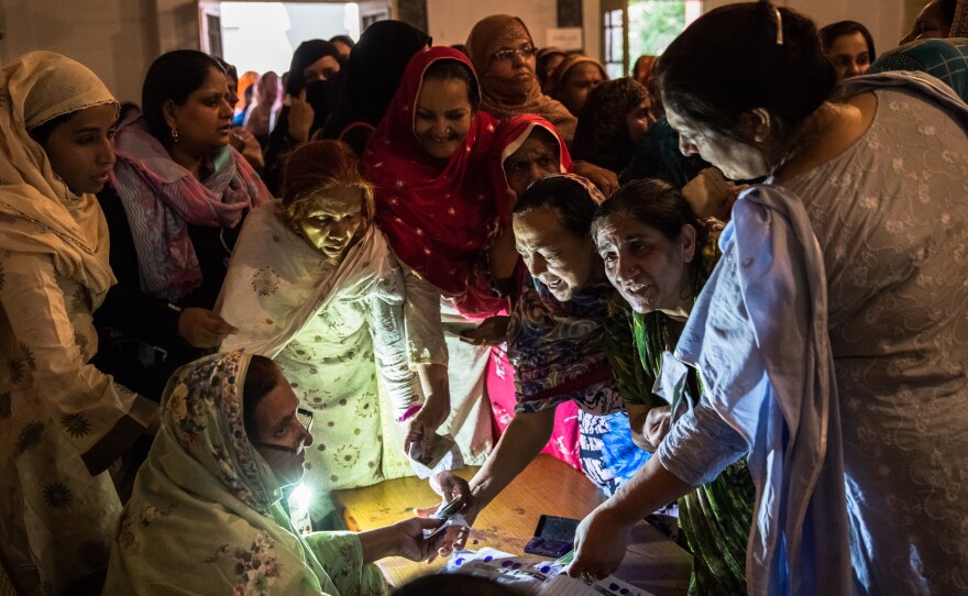 Pakistani women jostle to receive their ballot papers prior to casting their ballot at a polling station on May 11, 2013 in Lahore. A study in The Lancet provides evidence that free and fair elections are associated with a lower burden of chronic diseases.