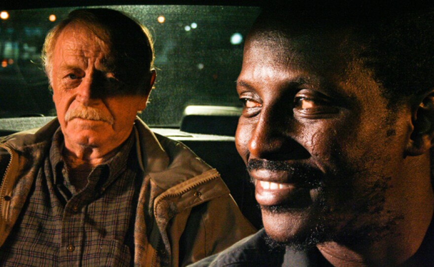 William (Red West) and Solo (Souléymane Sy Savané) in Solo's cab. Solo drives William to a mountaintop where he plans to commit suicide. Through this unlikely, but unforgettable friendship, "Goodbye Solo" deftly explores the passing of a generation, as well as the rapidly changing face of America.