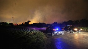 Smoke rises in the distance about half a mile from the West Fertilizer Company April 18, 2013 in West, Texas.