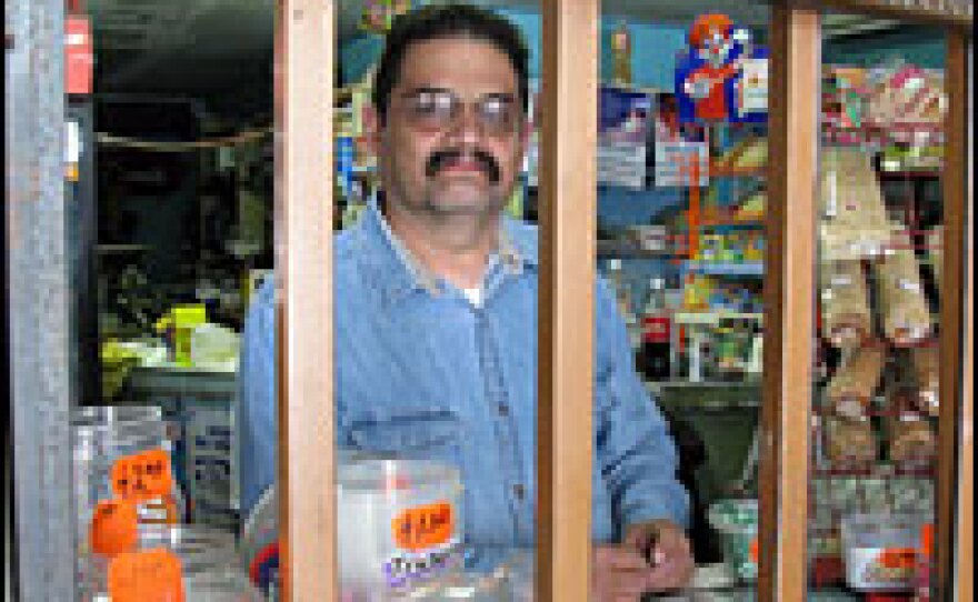 Miguel Navar runs a small convenience store in downtown Juarez. Last year, his store was robbed at gunpoint four times in six months. Recently, he installed metal bars across his front counter. He jokes that he's living in a cage while delinquents run free.