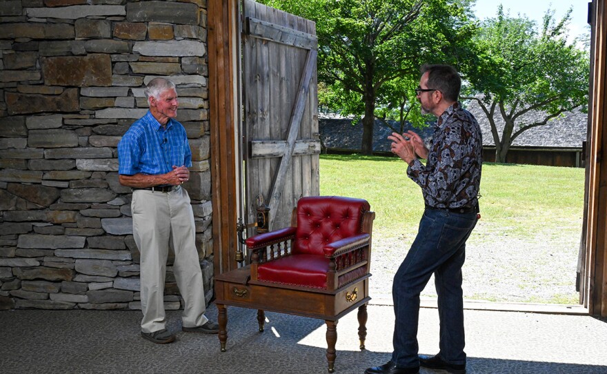 Gary Piattoni (right) appraises a Victorian jockey chair scale, ca. 1890, in Shelburne, VT.
