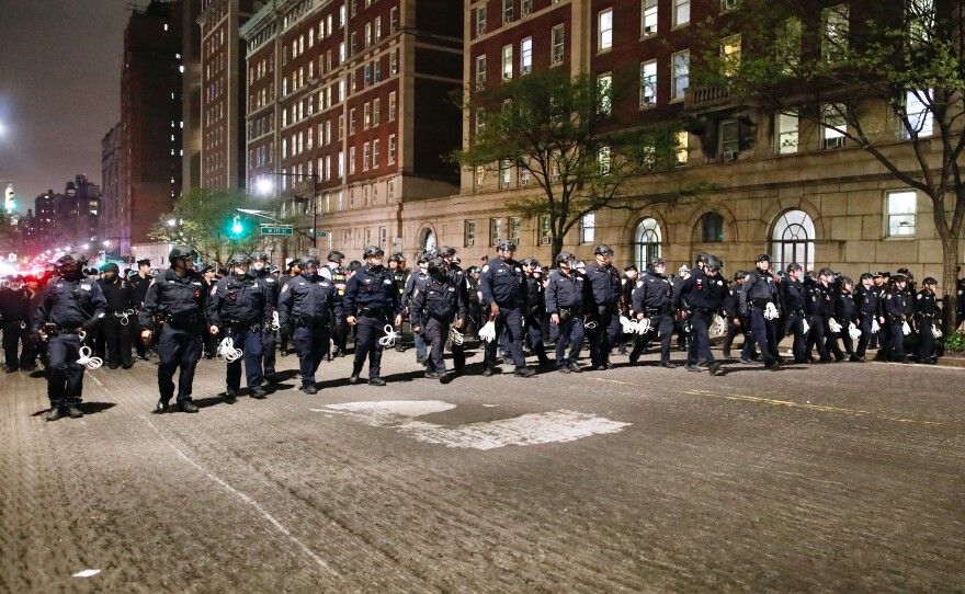 NYPD officers in riot gear march onto Columbia University campus, where pro-Palestinian students are barricaded inside a building and have set up an encampment, in New York City on April 30, 2024.