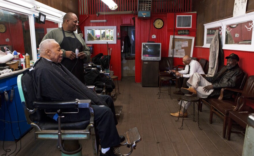 Petersen (right) visits Gregg's Barber Shop, which has been in the same location since 1913. Gennaro Ballard (center) says that the biggest change in Shaw has been the people. He has been a barber at Gregg's for 10 years.