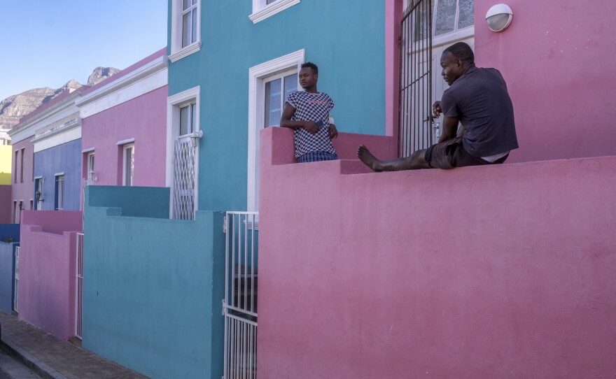 Young men pass the time on their front porch in Bo Kaap, a predominantly Muslim area of central Cape Town and a popular tourist site. Out of work since the start of South Africa's coronavirus lockdown, the men say they are worried that their savings will not last much longer.