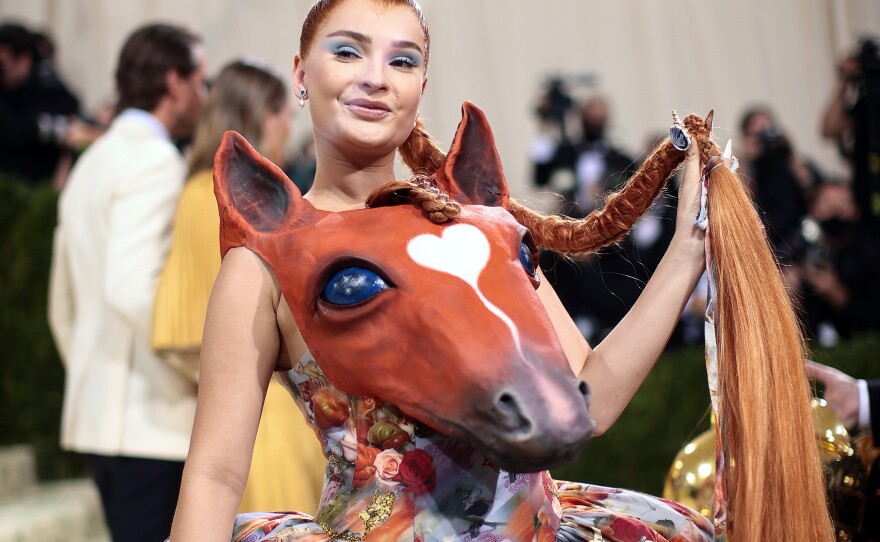 <a href="https://www.polygon.com/entertainment/2020/11/23/21591194/polygon-horse-girl-canon-list-stories">Calling all horse girls</a>: Kim Petras wears a <a href="https://www.vogue.com/fashion-shows/designer/collina-strada">Collina Strada</a> dress with a 3D horse bustier and dramatic skirt.