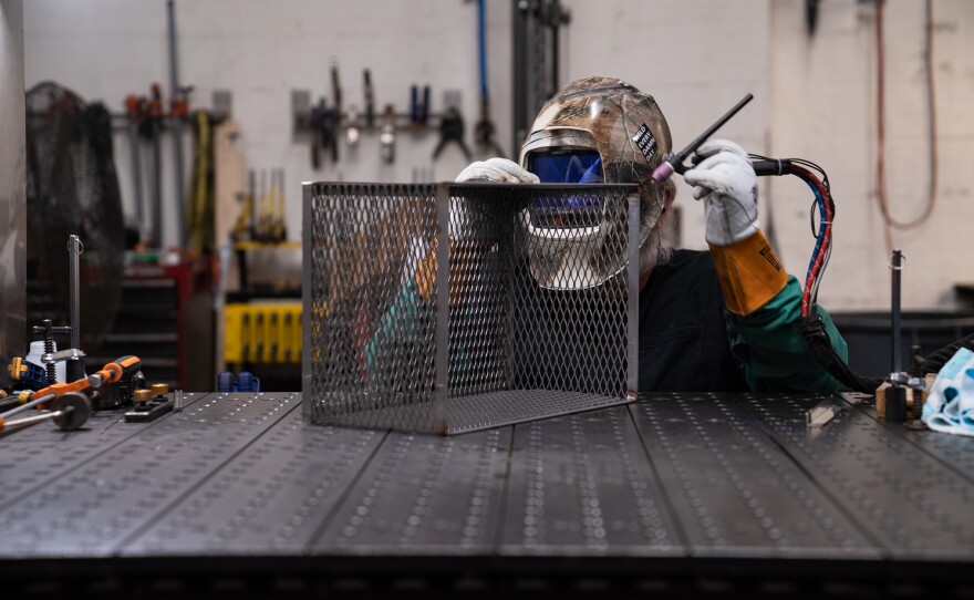 A welder works on a basket at Marlin Steel's Baltimore factory on March 22, 2023.