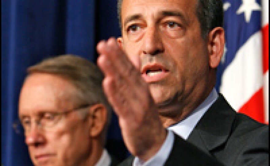 Sen. Russell Feingold (D-WI) (right), answers questions during a news conference with Senate Majority Leader Harry Reid (D-NV) about Iraq war funds.