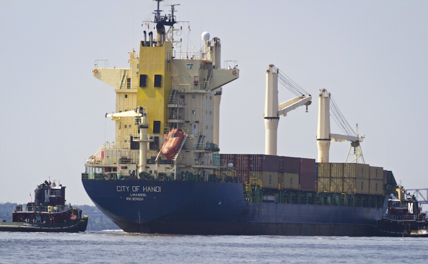 Tugboats guide a container vessel on the Jacksonville harbor. The city has secured about $150 million for the dredging project, but the total bill is expected to reach $700 million.