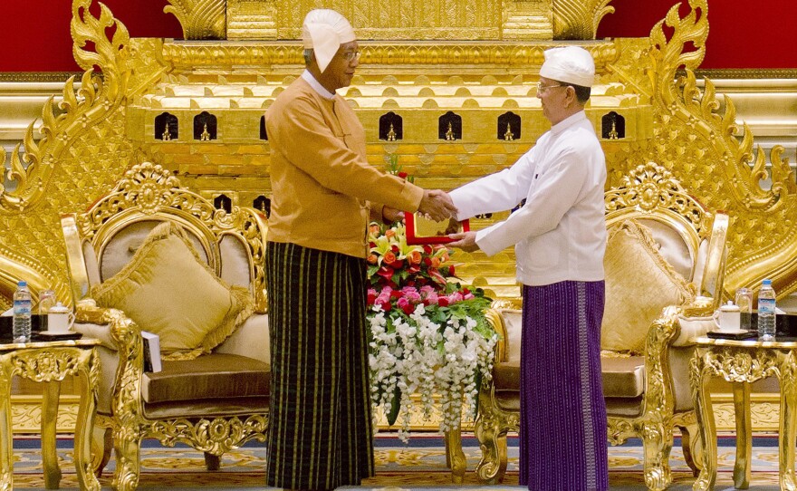 Myanmar's new president U Htin Kyaw (left), receives the presidential seal from outgoing president U Thein Sein during a handover ceremony at the presidential palace in Naypyidaw on Wednesday. The military ruled Myanmar, directly or indirectly, for more than a half-century.