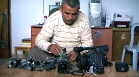 Co-director Emad Burnat with his five broken cameras.