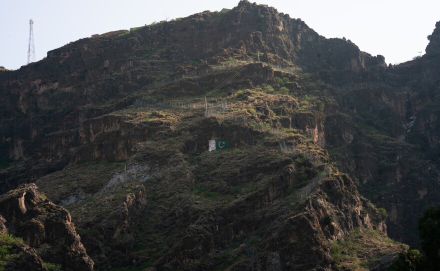 The border fencing between Pakistan and Afghanistan extends up the mountains near Torkham.