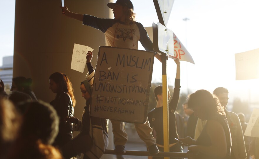 A demonstrator takes a photograph during a rally at San Francisco International Airport to protest President Trump's executive order.