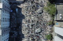 Residents and rescue workers search through the rubble after an earthquake struck Cali, Colombia, Monday, Aug. 10, 2026.