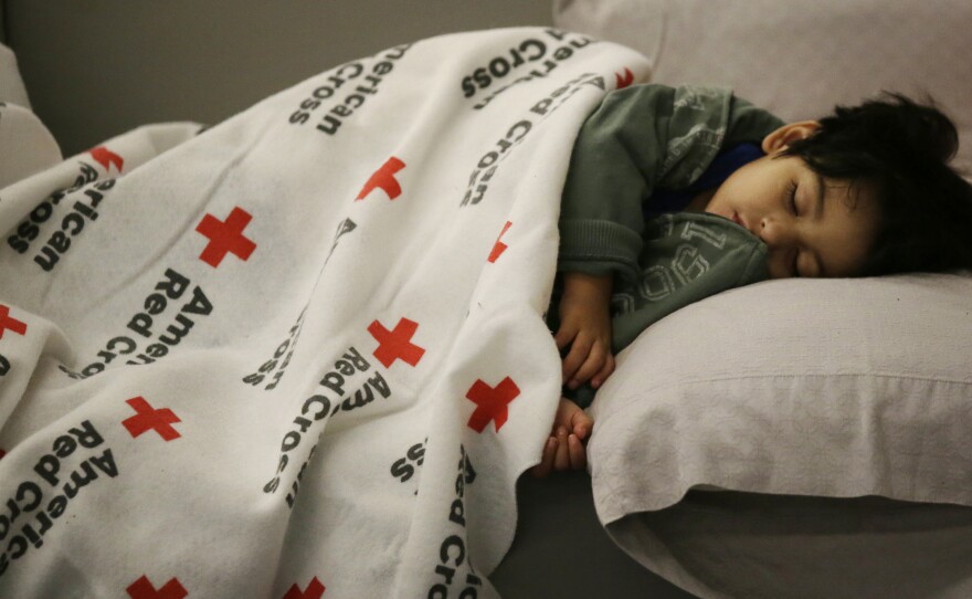 Malachia Medrano, 2, sleeps at the George R. Brown Convention Center in Houston, which has been set up as a shelter for people escaping the floodwaters from Hurricane Harvey.