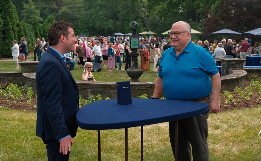 John Colasacco (left) appraises an art deco sapphire & diamond brooch, ca. 1915, in Akron, Ohio. ANTIQUES ROADSHOW “Stan Hywet Hall & Gardens, Hour 3” premieres Monday, May 13 at 8/7C PM on PBS.