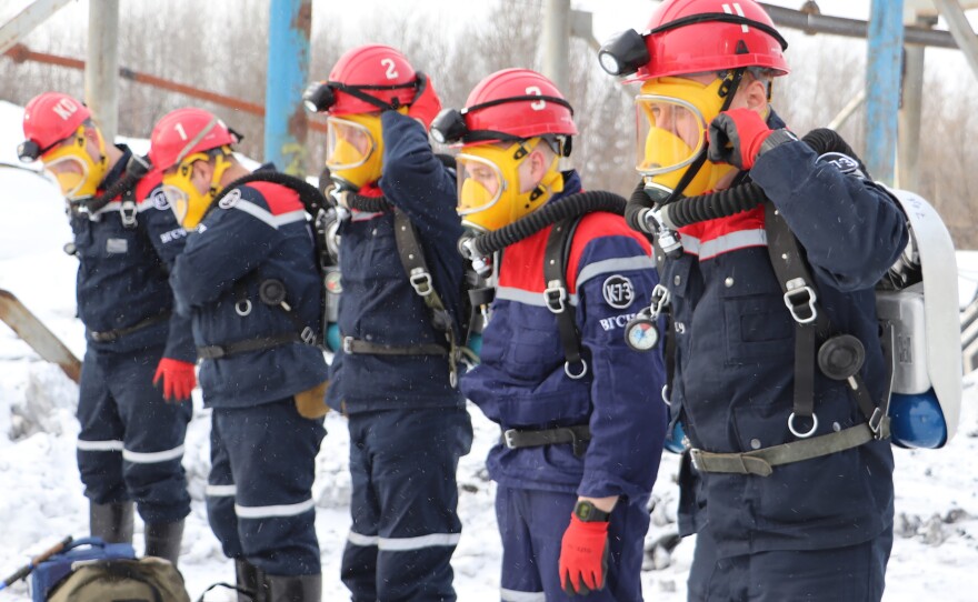 In this Russian Emergency Situations Ministry Thursday, Nov. 25, 2021 photo, rescuers prepare to work at a fire scene at a coal mine near the Siberian city of Kemerovo, about 3,000 kilometres (1,900 miles) east of Moscow, Russia,. Russian authorities say a fire at a coal mine in Siberia has killed nine people and injured 44 others. Dozens of others are still trapped.
