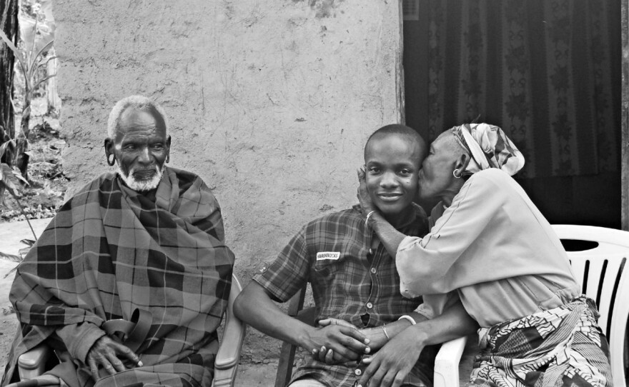 Godwin Ndosi of Tanzania (center) rents rooms in his family home through Airbnb and sometimes takes guests to visit his relatives, including his aunt and uncle (flanking Ndosi).