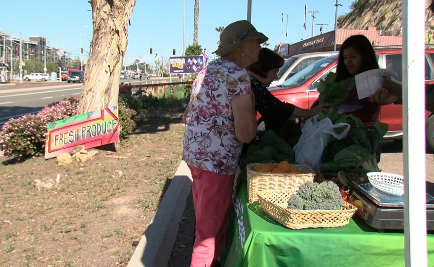 Students help customers at Second Chance Farm Stand, March 29, 2018.